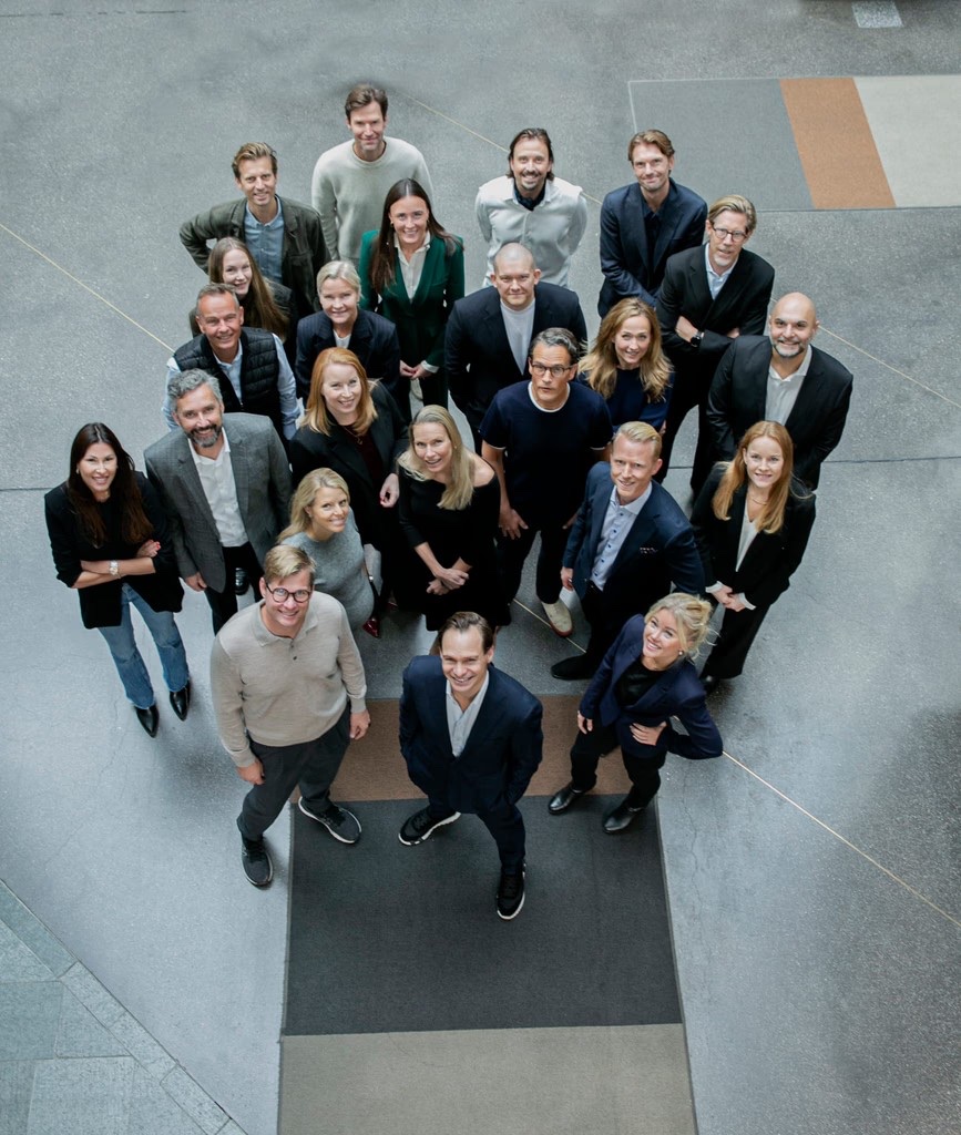 The Oryx team standing together in the Stockholm office, looking up at the camera.