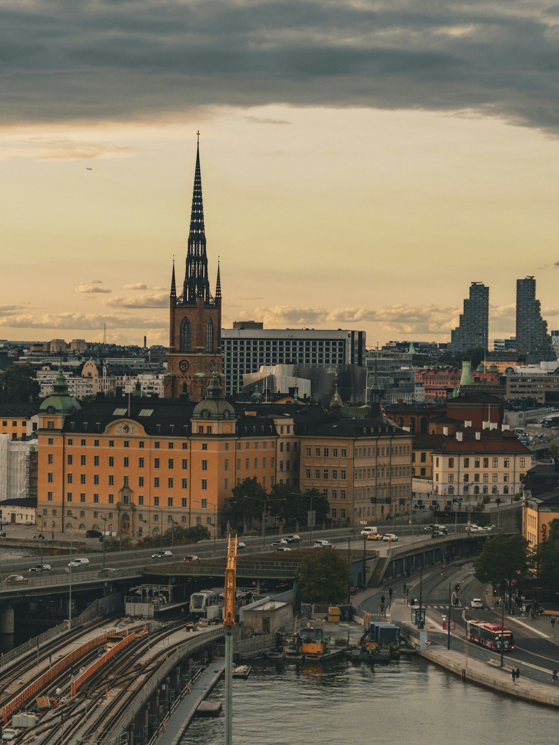 Stockholm skyline over the water, with church spires and the city hall tower.